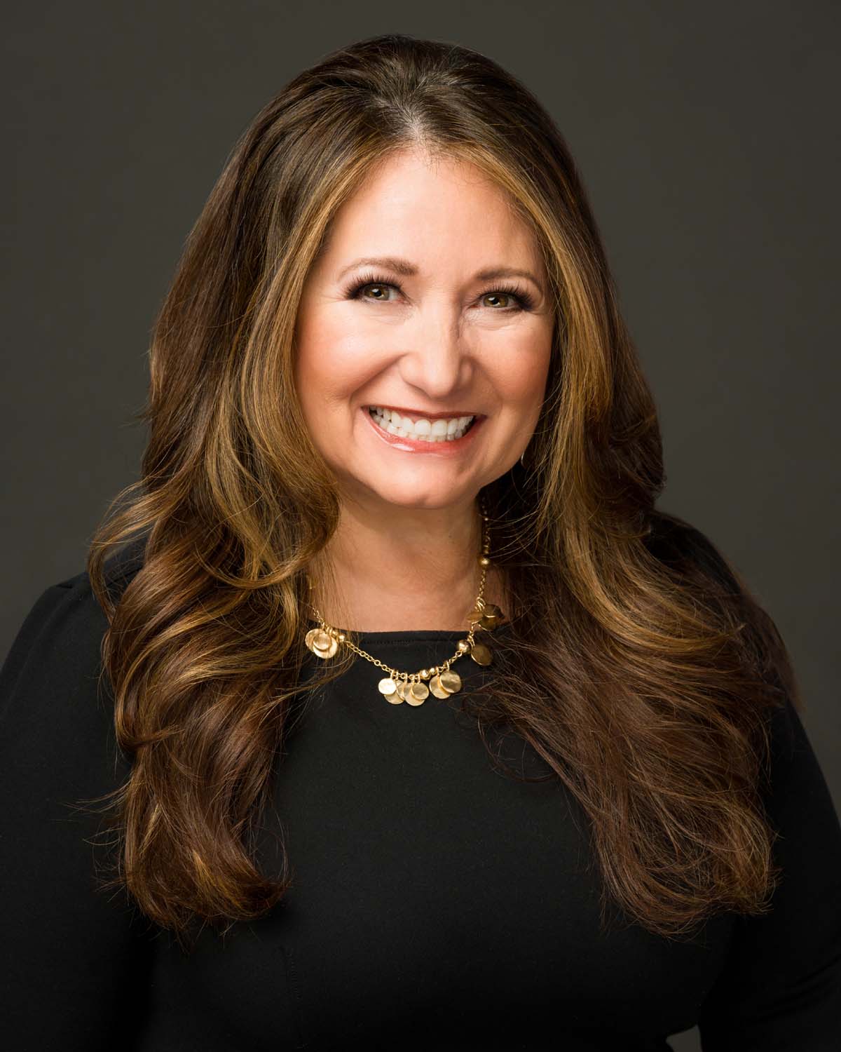 Professional branding headshot for business marketing, featuring a confident entrepreneur in a well-lit studio setting. Ideal for website bios, social media profiles, digital resumes, and business advertisements. This polished portrait highlights professionalism and approachability.