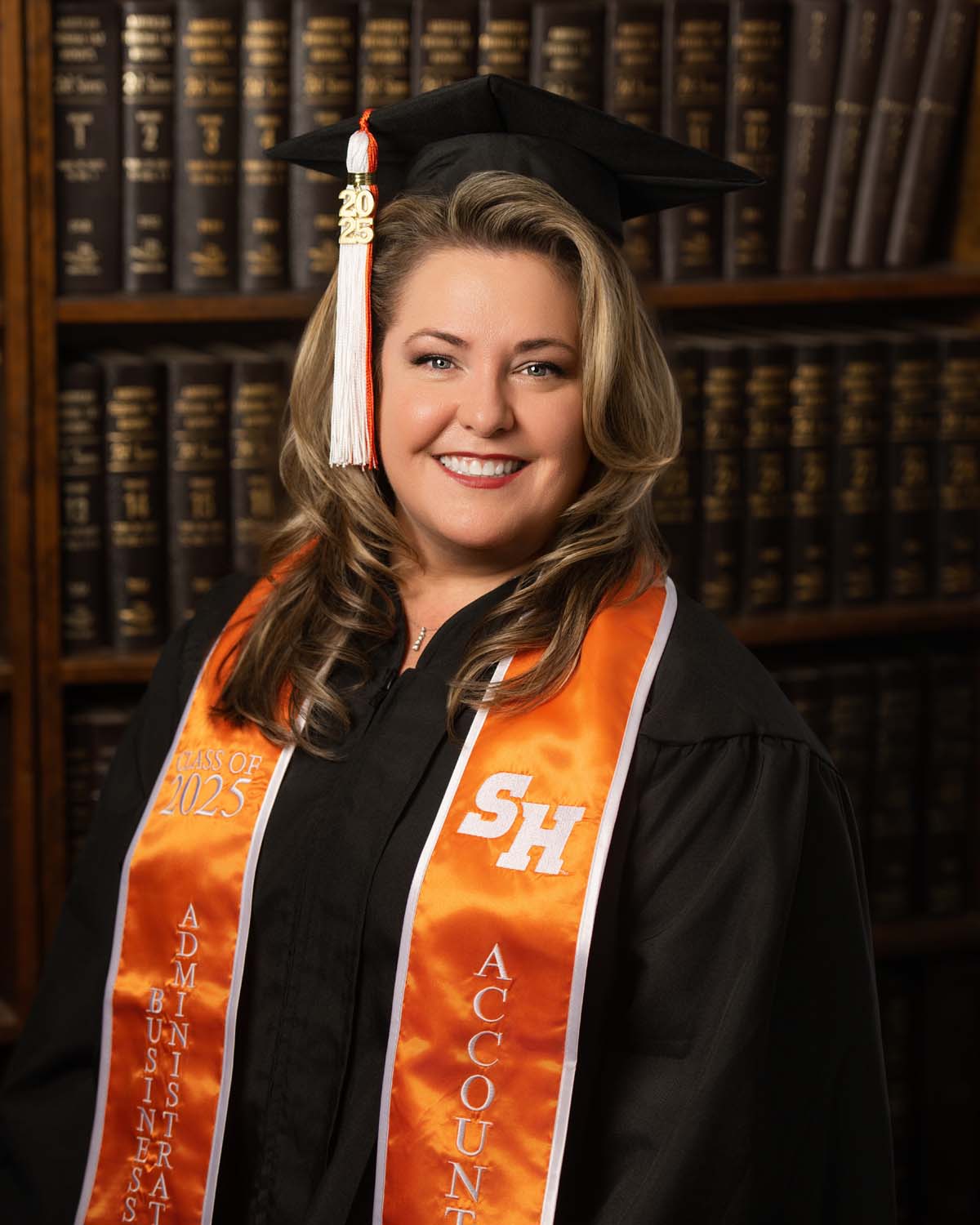 Professional headshot of a female attorney in a tailored suit, captured in-studio by Houston headshot photographer Melanie Hall of Melonhead Photo.<br />
